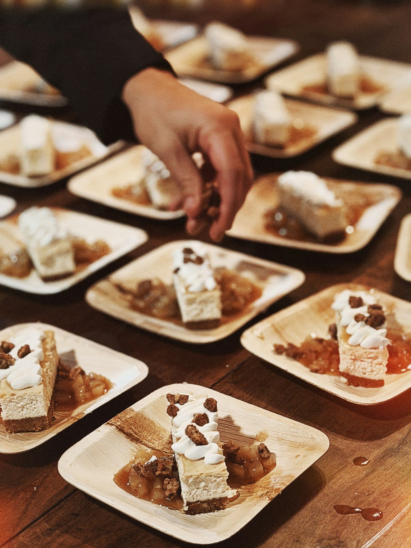 Artfully plated dessert squares with cream and candied pecans, served at a festival table